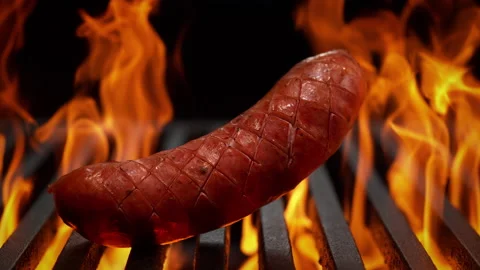 Raw Sausage Falling onto Grill Grate in Slow Motion - BBQ on Black Background 스톡 동영상 196878420