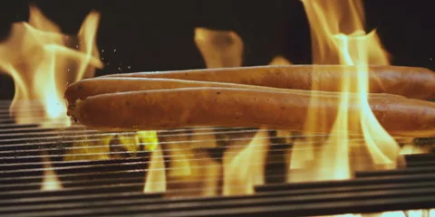 Raw sausages falling on the grill Video stock 247386526