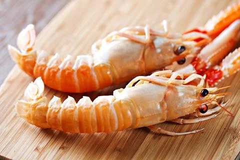 Raw scampi on cutting board . High quality photo. Stock Photos
