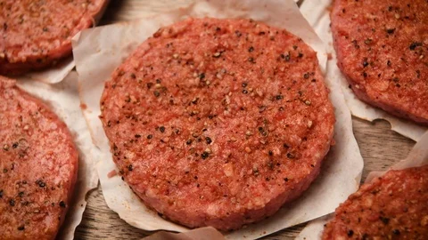 Raw seasoned Organic Angus beef hamburger patties Stock Footage 115091153