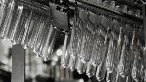 The raw shape of a plastic water bottle on a conveyor belt. Stock Footage 288792809