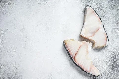 Raw Shark fish steaks on a kitchen table. White background. Top view. Copy space Stock Photos