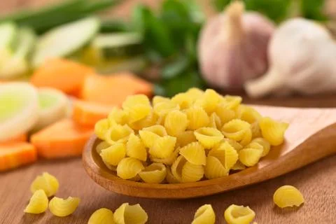 Raw shell pasta with vegetables Stock Photos