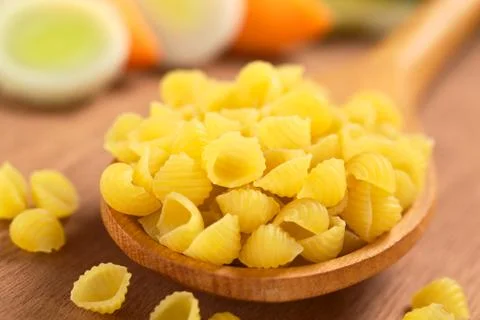 Raw shell pasta with vegetables Stock Photos