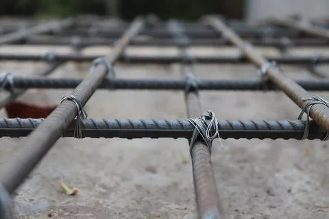 Raw shot featuring rust rebar fixed with thin wire, creating a grid pattern o Stock Photos
