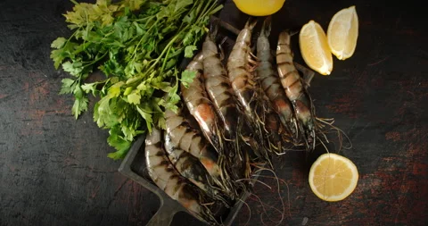 Raw shrimp with herbs and lemon slices rotate. Stock Footage 141615237