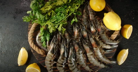 Raw shrimp with lemon slices and herbs rotate. Stock Footage 141619963