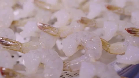 Raw shrimp tails on a white colander background. Stock Footage 337440420