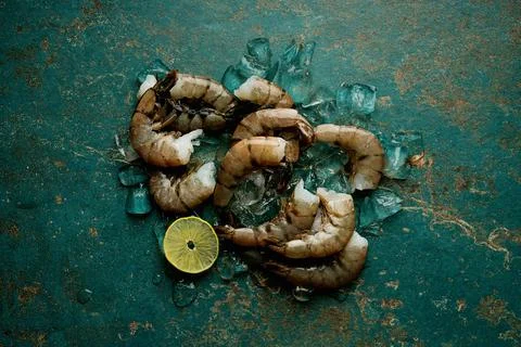 Raw shrimps on the dark rustic background Stock Photos
