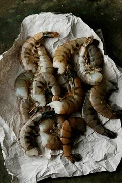Raw shrimps on the dark rustic background Stock Photos