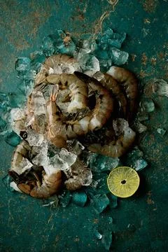Raw shrimps on the dark rustic background Stock Photos