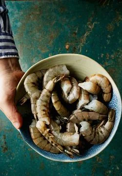 Raw shrimps on the dark rustic background Stock Photos