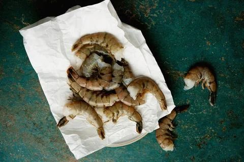 Raw shrimps on the dark rustic background Stock Photos
