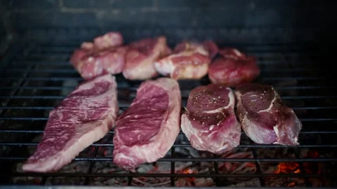 Raw sirloin beef steaks and meat pieces grilling over hot charcoal embers i.. Stock Footage 339764764