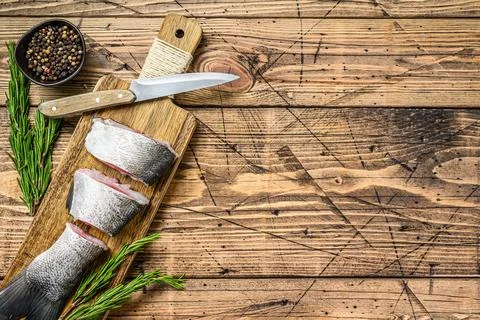Raw sliced fish silver carp. wooden background. Top view. Copy space Stock Photos