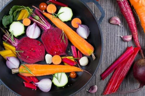 Raw sliced vegetables for roasting, on a baking tray. Assortment of vegetables Stock Photos