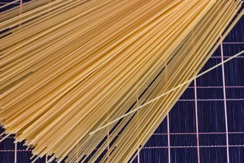 Raw spaghetti on a checkered dark table Stock Photos