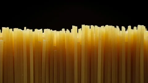 Raw spaghetti isolated on black background, slider shot 스톡 동영상 239619265
