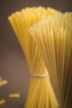Raw Spaghetti Pasta Bundle Tied on Dark Background Stock Photos