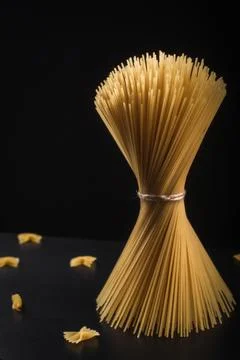 Raw Spaghetti Pasta Bundle Tied on Dark Background Stock Photos