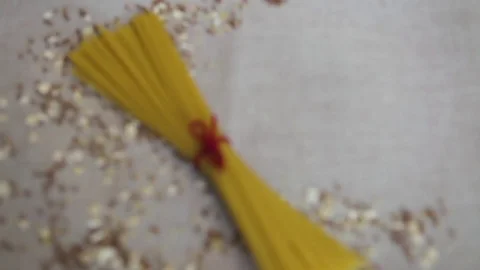 Raw spaghetti pasta, tied in a bun, lots, wallpaper, background, empty space. Stock Footage 74701608