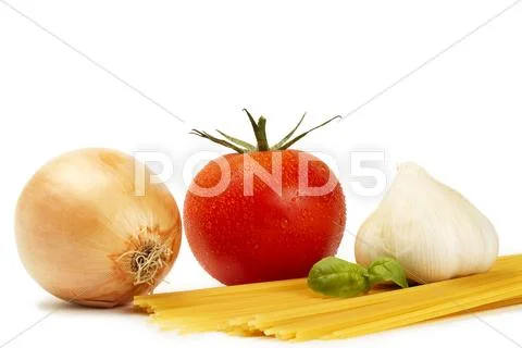 Raw spaghetti with tomato, basil, garlic and onion Stock Photos