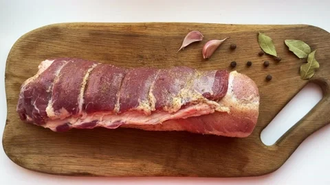 Raw spicy pork roll cooked for frying. Sprinkled with different spices on a Stock Footage 235361379