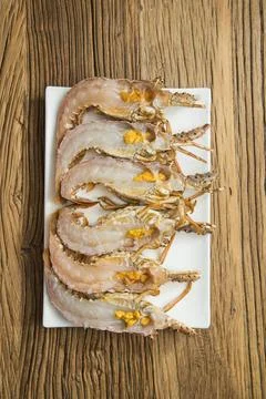 Raw split prawns neatly arranged on tray 写真素材