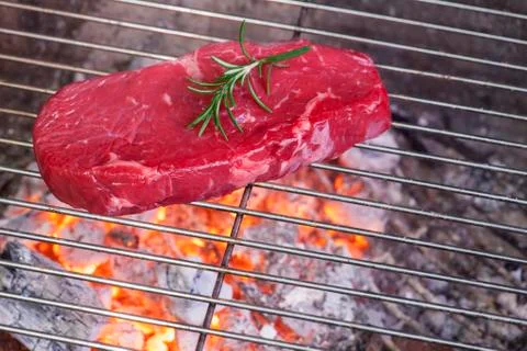 Raw steak on the bbq Stock Photos