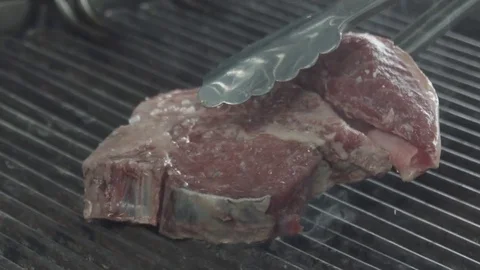 Raw steak frying Stock Footage 80689458