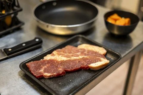 Raw Steak On Kitchen Table Stock Photos