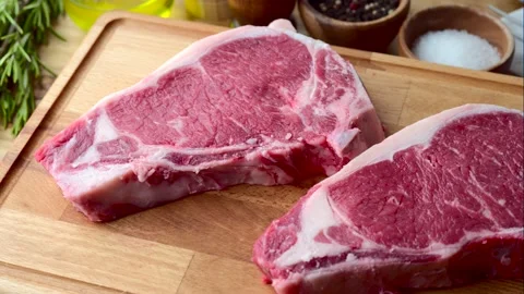Raw steak meat on cutting board in bright kitchen	 Stock Footage 143127969