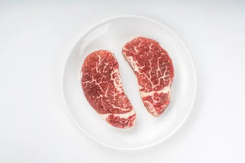 Raw steak on a plate Stock Photos
