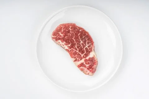 Raw steak on a plate Stock Photos