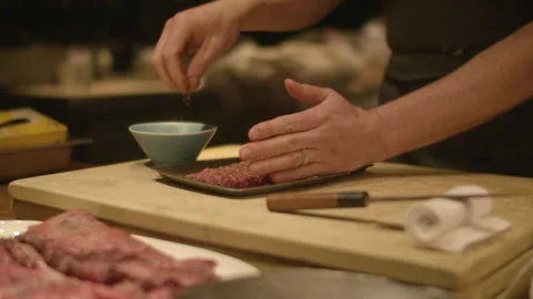 Raw Steak Pressed And Sprinkled With Seasoning By Chef, Slow Motion, Close-Up Stock Footage 311120881