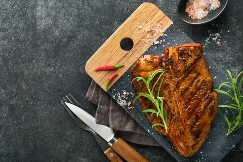 Raw steak t-bone or porterhouse. Steak t-bone or porterhouse in sauce with sp Stock Photos