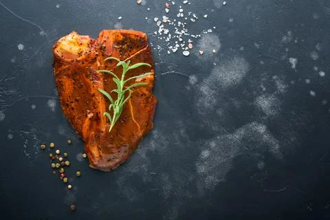 Raw steak t-bone or porterhouse. Steak t-bone or porterhouse in sauce with sp Stock Photos