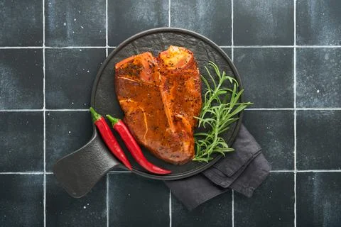 Raw steak t-bone or porterhouse. Steak t-bone or porterhouse in sauce with sp Stock Photos
