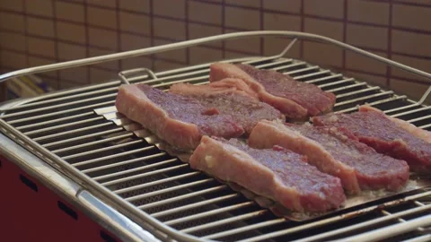 Raw steaks on a grill Stock Footage 130266797