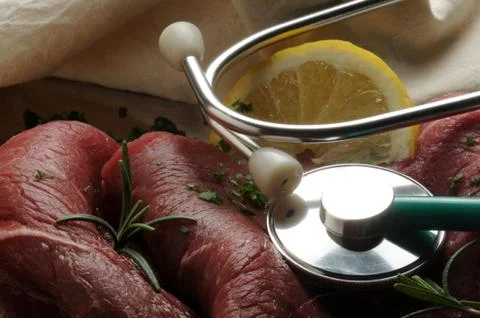Raw steaks with herbs and stethoscope Stock Photos