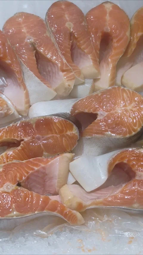 Raw steaks of trout chilled on shallow ice at the seafood market. Stock Footage 308697945