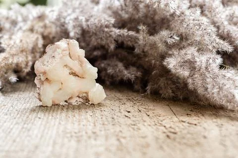 Raw Stilbite crystal sample on wood with copyspace Stock Photos