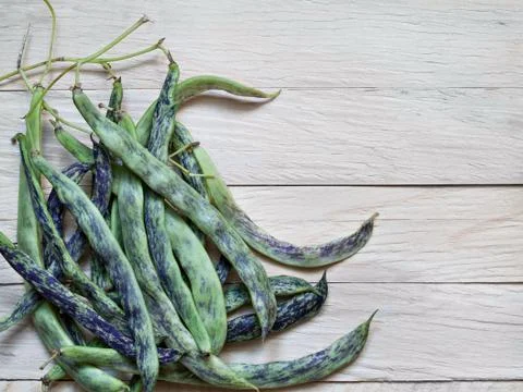A raw string bean is a heap on a plank background Stock Photos