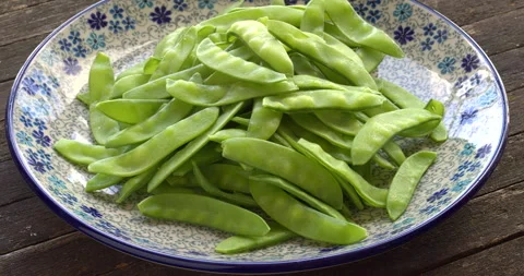 Raw sugar snap pea on a plate. Stock Footage 307946055
