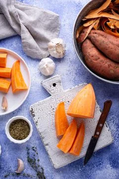 Raw sweet potato with herbs and garlic Stock Photos