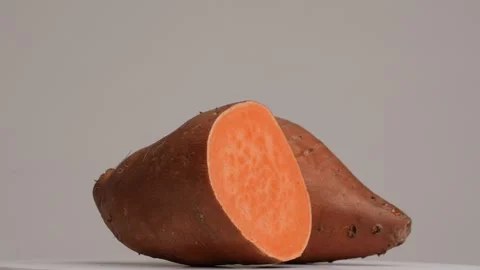 Raw Sweet Potato rotating in a studio shot Stock Footage 249924392