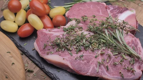 Raw T-bone steak with fresh spices slow motion Stock Footage 95582770