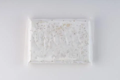Raw tempeh in plastic wrap Stock Photos