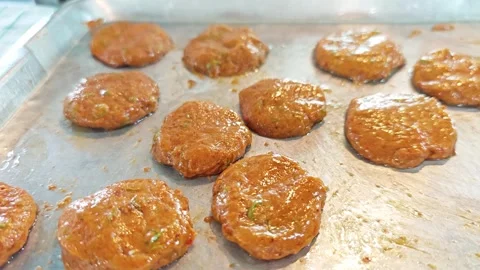Raw Thai fish cakes prepared on a metal tray. Stock Footage 342394512