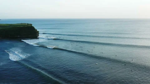 Raw of tidal waves with group of surfers in Bali Stock Footage 132613264